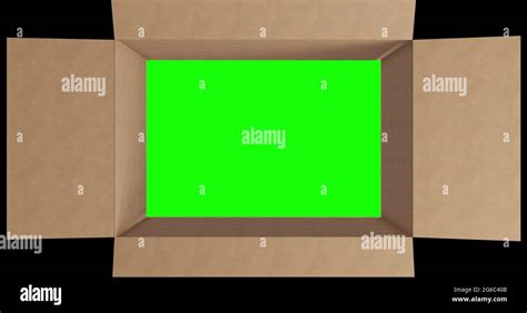 Overhead of green screen in brown cardboard box with lid closing on black background Stock Photo ...