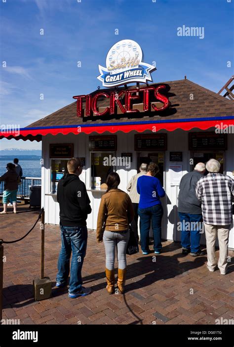 Tourists buying tickets for Seattle Great Wheel at ticket booth ...