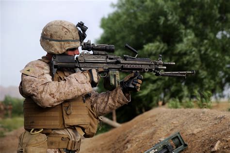 U.S. Marine Corps Lance Cpl. Jonathan Griffiths provides security with an M249 squad automatic ...