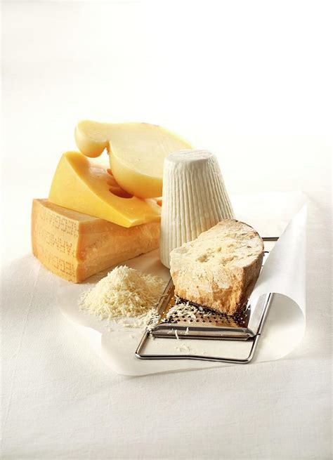 Five Grateable Hard Cheeses, Grated Cheese And A Cheese Grater Photograph by Franco Pizzochero