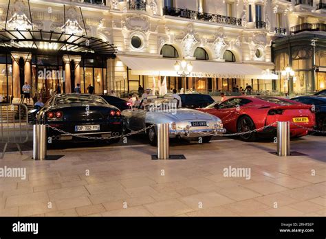 Exotic cars parked outside Hotel de Paris in Casino Square in Monte ...