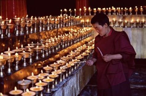 Tibet Butter Lamp Festival | Monk lighting butter lamps to worship Buddha. (Getty Image) | Tibet ...