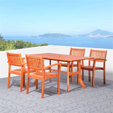 Hakan Wood Patio Curvy Legs Table and Stacking Chair Set - Bed Bath ...