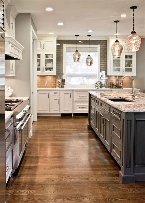 Gray Island with White Cabinets and Granite Top in a Modern Kitchen