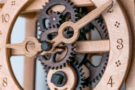 a wooden clock with gears attached to it