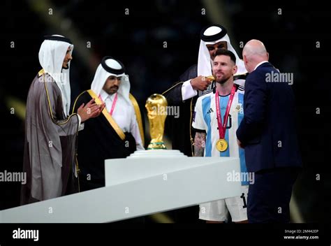 The Emir of Qatar, Sheikh Tamim bin Hamad Al Thani presents Argentina captain Lionel Messi with ...