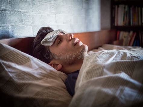 Young Handsome Sick or Unwell Man in Bed with a Flu or Fever Stock Photo - Image of fever ...