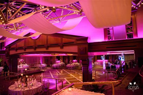 the inside of a banquet hall with purple lighting