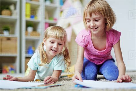 Happy kids playing together in kindergarten - Stock Photo - Dissolve