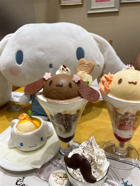 three ice cream sundaes on a table next to a stuffed animal