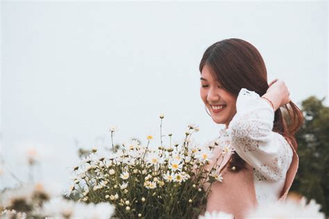 Woman Smiling Near Flowers · Free Stock Photo