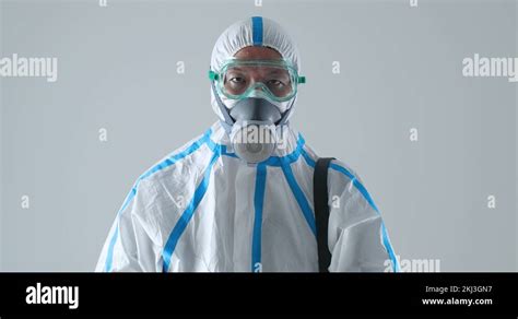 Japanese man wearing full body hazmat suit disinfecting, disease prevention Stock Video Footage ...