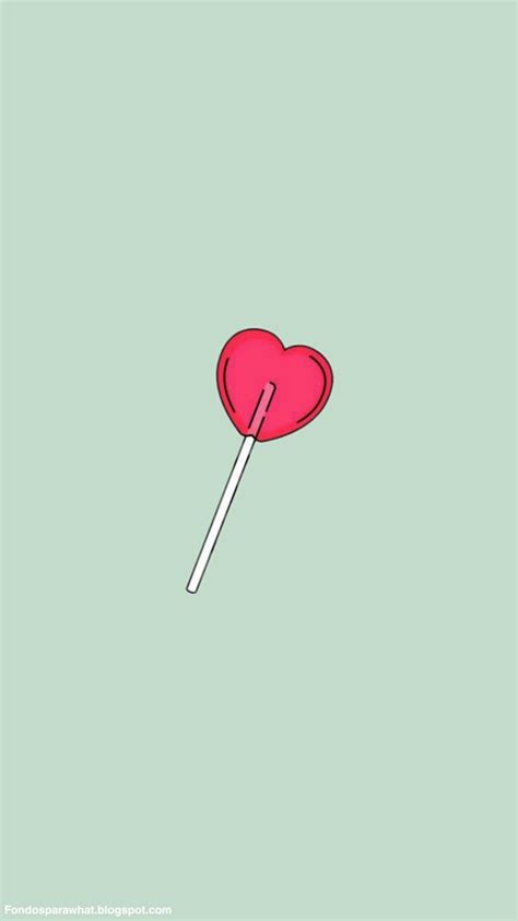 a heart shaped lollipop on a green background