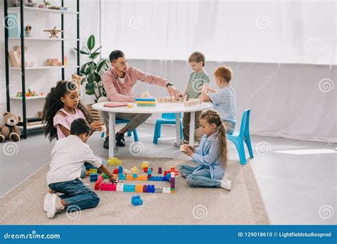 Teacher and Multicultural Preschoolers on Floor with Colorful Bricks Stock Photo - Image of boys ...