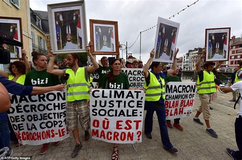 Protesters carrying upside-down portraits of Emmanuel Macron march near G7 site | Daily Mail Online