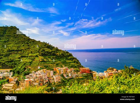 colorful houses overlooking deep blue sea in Italy Stock Photo - Alamy