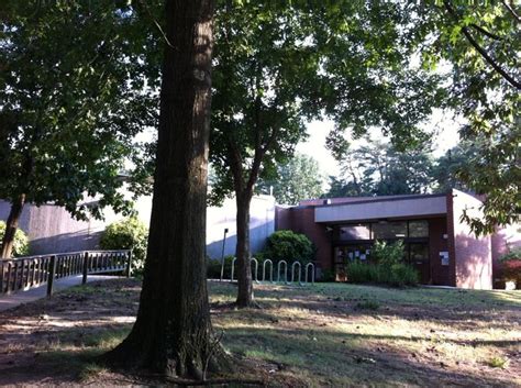 the building is surrounded by trees and grass