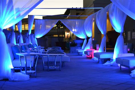 Miami Themed Rooftop Party- Lounge area with couches, tables, LED up-lighting and draping. Shed ...