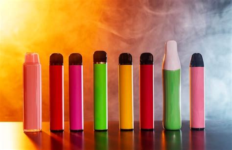 Premium Photo | A set of colorful disposable electronic cigarettes of different shapes on a ...