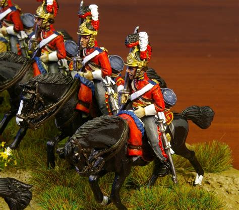 the toy soldiers are riding their horses in uniforms and hats with ...