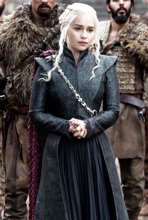 the game of thrones character is standing with other characters in front of him and wearing black