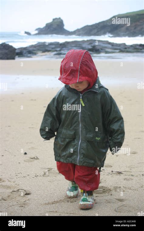 Boy walking in the rain Stock Photo - Alamy