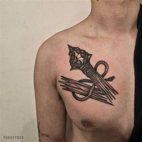 Broken spear tattoo on the chest - Tattoogrid.net