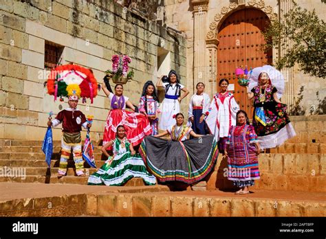 Group of people in traditional Mexican clothing posing in midday sun at ...