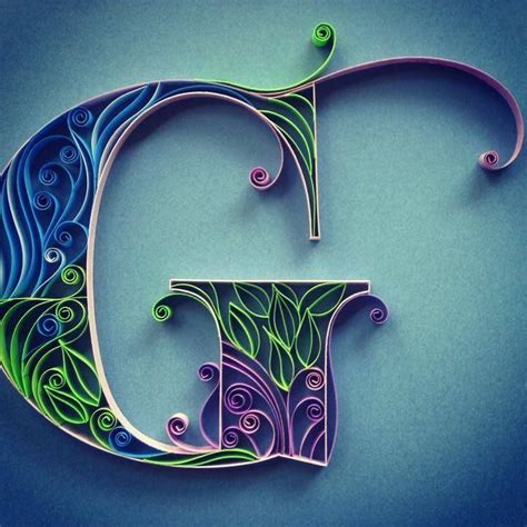 the letter c is made out of paper and has swirly designs on it's sides