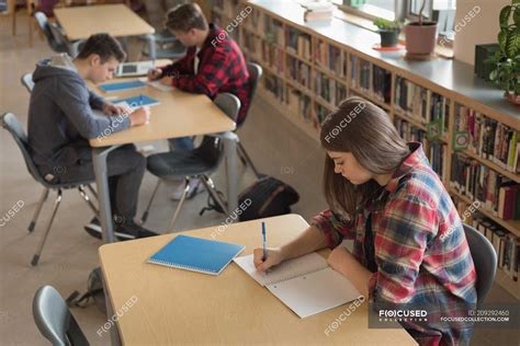 College students studying in library at university — teenagers, modern - Stock Photo | #209292460