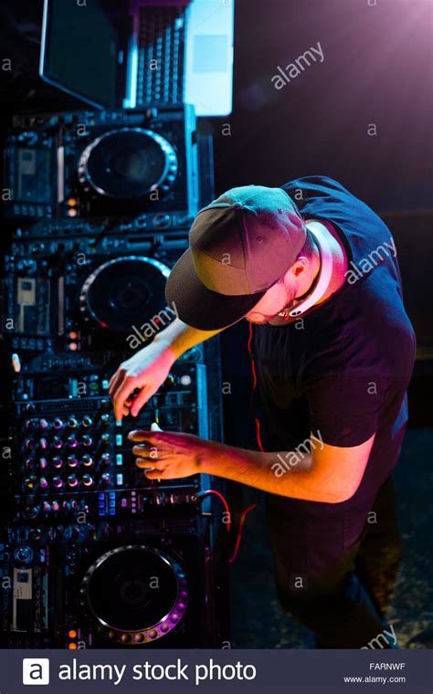 DJ man mixing electronic music on stage. Shot from aerial view Stock Photo - Alamy