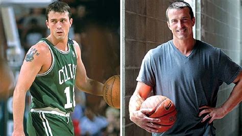 two men in green jerseys holding basketballs next to one man with his ...