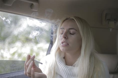 Premium Photo | Close-up of beautiful woman smoking in car