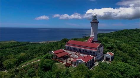 an aerial view of a lighthouse surrounded by trees