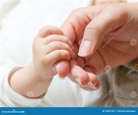 Baby holding mother hand stock image. Image of parent - 24941587