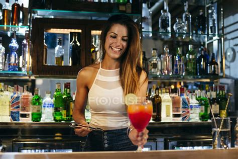 Female bartender serving cocktail — lime, liquor - Stock Photo | #164961492