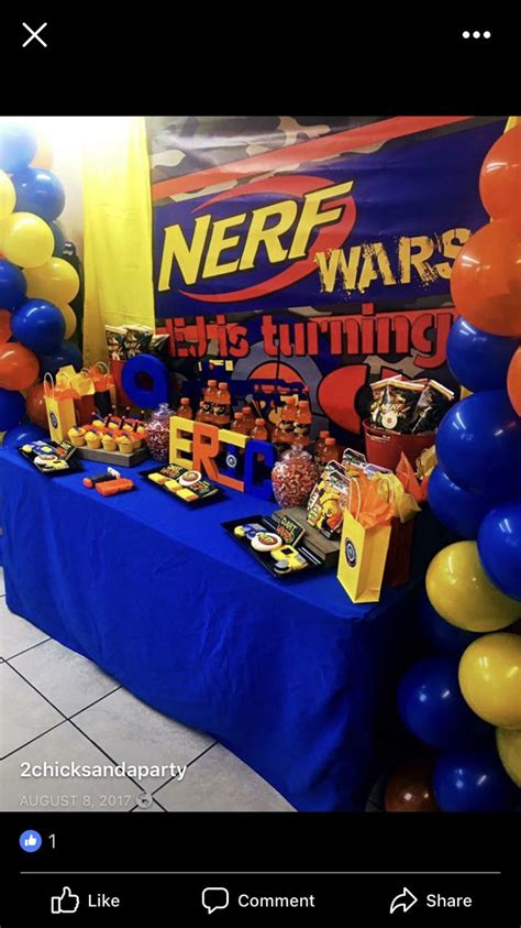an image of a table set up for a nerfwars birthday party with balloons