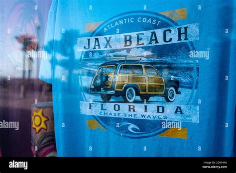 Jax Beach surfing t-shirt seen through the storefront window of an oceanfront souvenir shop ...