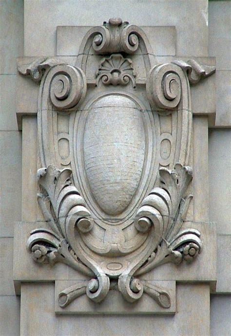 an ornate crest on the side of a building