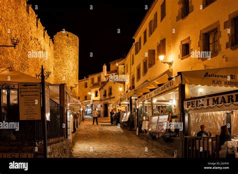 Tossa de Mar at night, cobbled alley with restaurants, cafes next to Stock Photo, Royalty Free ...