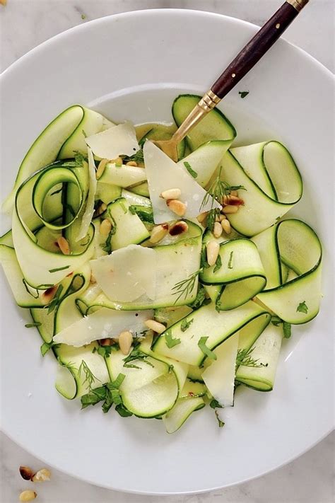 the secret to the deliciousness of this raw courgette salad is the ...