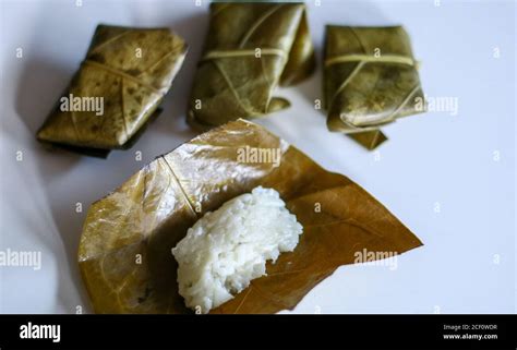 Fermented sticky (tape ketan) wrapped in guava leaves on white background Stock Photo - Alamy