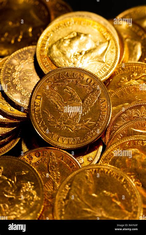 Real Gold coins over dark background Stock Photo - Alamy