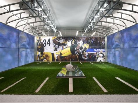 an indoor football stadium with artificial turf