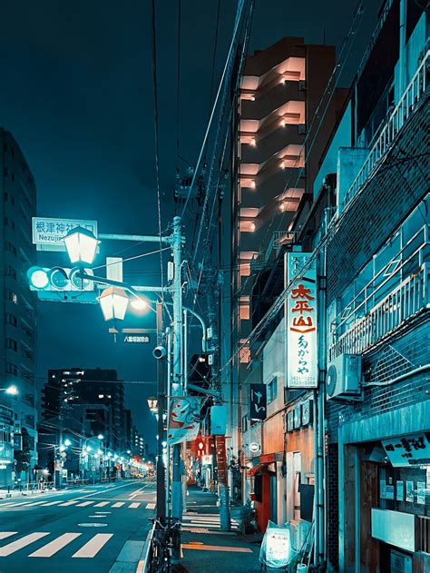 A city street at night with buildings and street lights photo – Free Urban Image on Unsplash