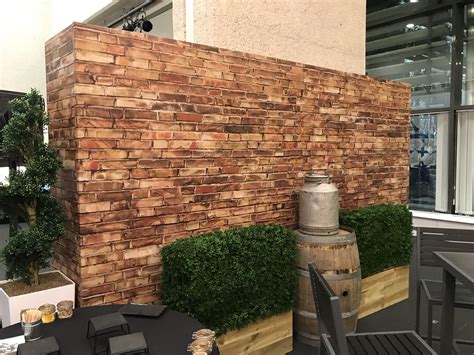 Free Standing Brick wall designs to cover old walls. - Plants and other props used to bring the ...