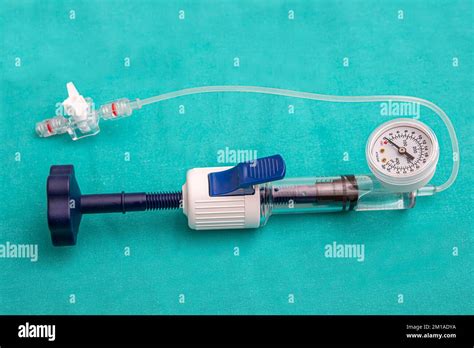 A balloon inflation device used in angioplasty procedure. Mesh metal balloon-expandable stent ...