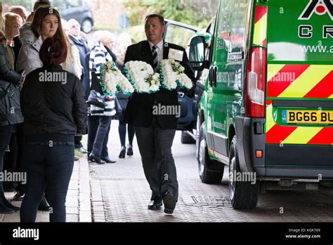 Flowers from ABA Crane Hire are carried into the Streetly Crematorium in Walsall for the funeral ...