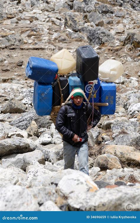 Sherpa Porter Carry Heavy Load In The Himalaya At Everest Base Camp ...