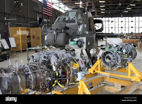 The engines of an AH-64 Apache helicopter await to be hoisted and ...